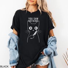 Looking for the perfect funny Halloween cat shirt? Our custom tees are super soft, comfortable to wear, and fit like a well-loved favorite. All orders ship within 1-3 business days and are backed by our Love It Guarantee. ✅ SHIRT FEATURES - Super Soft Feel - Crisp Graphic Print - Custom Design - True Fit Wear - Eco-Friendly Process - Love it Guarantee 📦 PROCESSING & SHIPPING All apparel ships within 1-3 business days and takes another 2-5 days in transit. Your custom shirt will be there before Funny Tshirts For Women Graphic Tees, Black Relaxed Fit T-shirt With Cat Print, Spooky Cat Print Crew Neck T-shirt, Spooky Cotton T-shirt With Cat Print, Casual Halloween Cat Design T-shirt, Black Relaxed Fit Tops With Cat Design, Black Relaxed Fit Top With Cat Design, Funny Black T-shirt With Cat Design, Spooky Black T-shirt With Cat Print