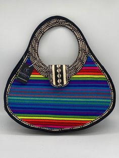 These beautiful handbags are made from Cana Flecha which is an indigenous palm fiber found in the northern territory of Colombia. They are beautifully hand crafted by the people from the Zenu tribes in Colombia. These handbags are colorful with vibrant colors, which is a pure reflection on the region and the warmness of these master artisans that work in this industry every day. Traditional Straw Tote Bag For Everyday Use, Traditional Top Handle Woven Bag, Traditional Woven Top Handle Bag, Traditional Shoulder Bag With Braided Handles, Traditional Multicolor Straw Bag For Market, Artisan Multicolor Shoulder Bag With Handles, Artisan Shoulder Bag With Handwoven Top Handle, Artisan Handwoven Top Handle Shoulder Bag, Artisan Style Handwoven Top Handle Shoulder Bag