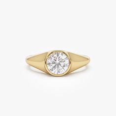 Introducing our 14K Gold Round Cut Lab Grown Diamond Signet Ring, featuring a 1.00 ctw diamond in a sleek bezel setting. This dainty unisex ring is perfect as an engagement or promise ring, offering a modern and refined style. Ideal for stacking, it makes a thoughtful birthday gift that blends elegance with versatility. Expertly crafted, this ring is a timeless addition to any jewelry collection. Every diamond featured in this listing is a "LAB GROWN" diamond. Features * Made to Order. * Gold KT: 14K (18K and Platinum Available upon Request) * Custom Gold Color: Rose Gold, Yellow Gold, White Gold * Width: 7.5 MM Graduates Down to 2.4 MM * Height: 4 MM * Round Shaped Lab Grown Diamonds: 1 Pc 6.5 MM * Total CTW: 1.00 ctw  * Diamond Color-Clarity: E-F Color VS Clarity ▶ Want to find out more? Dainty Engagement Ring, Dainty Engagement, Dainty Engagement Rings, Diamond Signet Ring, Gold Armband, Refined Style, Unisex Ring, Diamond Bracelets, Gold Bangles