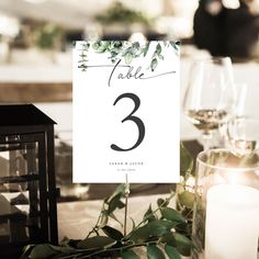 the table numbers are displayed with candles and greenery