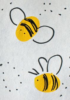 two yellow bees on white paper with black dots