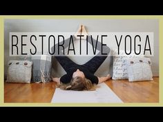 a woman laying on the floor with her legs crossed in front of her head while doing yoga