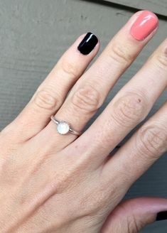 A lovely elegant small moonstone moonstone has been set in a sterling silver serrated bezel with a handmade ring band from sterling silver half dome wire. This dainty 6mm round moonstone has lovely hues of blues and hints of oranges and pinks throughout when the light hits it just right. The setting gives this ring a little bit of edge while still being minimalistic and elegant. Made to order! Each moonstone will vary slightly in coloration, hues, and flash.Moonstone is the birthstone for June! White Opal Dainty Birthstone Ring, White Dainty Opal Gemstone Ring, White Dainty Opal Birthstone Ring, White Dainty Opal Ring, White Opal Birthstone Ring In Dainty Style, Dainty White Opal Birthstone Ring, Delicate Sterling Silver Opal Ring, Delicate White Moonstone Gemstone Ring, Dainty White Solitaire Birthstone Ring