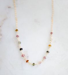 Bring some color and joy into your life with natural Tourmaline gemstones! Known to spark inspiration and happiness, this crystal is believed to build self-confidence and reduce fear. It's also thought to balance yin-yang energies and aid in detoxification. Plus, it's the perfect birthstone gift for those born in October.Our handcrafted necklace features genuine, faceted Tourmaline stones in a variety of colors (black, green, brown, and pink). Each necklace is unique with its own color pattern, Born In October, Yang Energy, Brown And Pink, Tourmaline Stone, Birthstone Gifts, Handcrafted Necklace, Tourmaline Gemstone, 14kt Gold, Green Brown