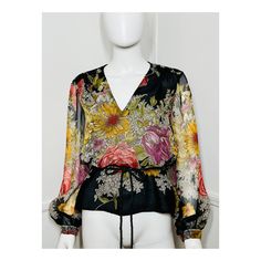 "1970s vintage black floral blouse by Alice Schweitzer. Black poly blouse with a large scale floral print. V neckline. Relaxed fit. Slight gathering across the shoulders. Sheer voluminous sleeves with button cuffs. The side seams of the blouse have slits to thread a belt through. My belt is not included. Pulls over the head, no closures. { LABEL- FABRIC- TAG SIZE } Alice Schweitzer Poly Labeled Size 12- refer to measurements { MEASUREMENTS } Shown on a 5'8\" Mannequin with 33\" Bust- 25\" Waist- 35\" Hips  Bust- 42\" Waist- 42\" Sleeves- 25\" Total Length- 24\" { CONDITION } Excellent Condition PLEASE READ BEFORE PURCHASING For best fit, please compare measurements to a garment of your own that fits comfortably and please measure yourself before completing your purchase. It is normal for h Floral Balloons, Large Scale Floral, Black Floral Blouse, Voluminous Sleeves, Balloon Sleeve Blouse, Fabric Tags, Floral Blouse, Black Floral, Womens Clothing Tops