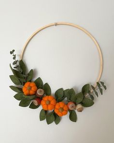 an orange and green wreath is hanging on the wall