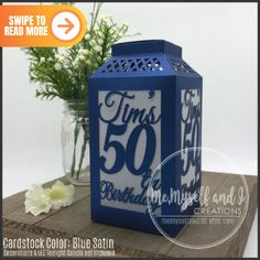 a blue box with the number 50 on it and some flowers in front of it