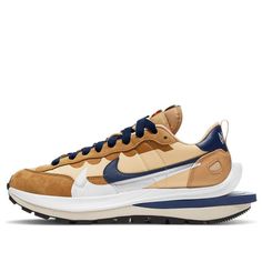 The sacai x Nike VaporWaffle "Sesame Blue Void" features a soft tan shade that takes over the fuzzy suede and neoprene upper body. To contrast the tan uppers, a royal accent from navy pops off brightly. This Vaporwaffle also has a double-stacked tongue tab, dual-tone laces, two Nike Swooshes, and the two-layered midsole with a foam plate crammed inside around the heel. SKU: DD1875-200 Release Date: Apr 29, 2021 Color: Velvet Brown/Dark Russet-Dark Curry-Sail (SNKR/Casual/Unisex/Low Top/Non-Slip/ Sacai Nike, Nike X Sacai, Nike React Element 87, Basket Nike, Running Shoes For Women, Nike Sacai, Fresh Sneakers, Nike Models, Baskets Nike