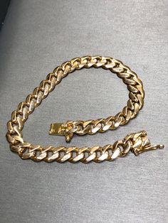 Vintage 18K rose gold Cuban curb link bracelet with box clasp. A classic and elegant link to be enjoyed by anyone. Each link is solid 18K rose gold with quite the heft. An impressive one to say the least. Dimensions/Weight. Bracelet measures 7.50mm wide and measures 8.25" long and weighs 34.9g. Condition: Some imperfections on end links but nothing offensive. Beautifully kept. B-ANBB Classic Cuban Link Chain Bracelet, Elegant Cuban Link Chain Bracelet For Formal Occasions, Elegant Cuban Link Curb Chain Bracelets, Elegant Bracelets With Cuban Link Curb Chain, Classic Cuban Link Chain Bracelet For Formal Occasions, Classic Gold Cuban Link Bracelet, Tarnish Resistant, Classic Gold Cuban Link Bracelet Tarnish Resistant, Classic Cuban Link Gold Bracelet, Tarnish Resistant, Classic Cuban Link Gold Bracelet Tarnish Resistant