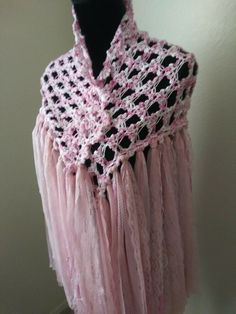 a pink shawl is hanging on a mannequin's headdress