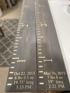 two wooden rulers sitting on top of a table next to each other with measurements printed on them