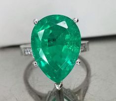 VINTAGE Platinum DIAMOND AND COLOMBIAN EMERALD RING IN PEAR SHAPECENTER 7.26 CARAT CENTER EMERALD LAB FLUX GROWTH COLOMBIA BERYL EMERALDGORGEOUS COLOMBIAN EMERALD AAA RATED!!CLEAN ,VERY NICE CUT ,AMAZING BRILLIANCE FULL OF FIRE,10 side natural diamonds 0.20ct. SI1 quality H- COLORsize 5.25Retail value $11,000 net .Appraisal available Gia Certified Green Pear-shaped Rings, Classic Green Pear-shaped Ring, Classic Pear-shaped Green Ring, Green Pear-shaped Brilliant Cut Emerald Ring, Pear-shaped Brilliant Cut Green Emerald Ring, Formal Pear-shaped Brilliant Cut Emerald Ring, Pear-shaped Brilliant Cut Emerald Ring, Formal Teardrop Emerald Ring, Green Pear-shaped Emerald Gemstone Ring