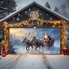 a garage decorated for christmas with santa riding in a sleigh and reindeers