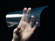 a hand holding a piece of clear plastic