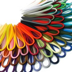 a bunch of different colored scissors sitting on top of each other