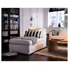 a living room filled with furniture and a book shelf