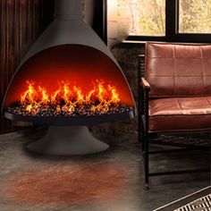 a modern fireplace in the middle of a living room with leather chairs and a large window