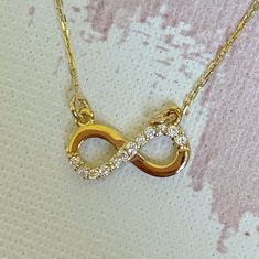 "This Infinity necklace is 14K Solid GOLD ( not filled or plated) furnished with cubic zirconia diamonds. All our gold pieces are suitable for all kinds of clothing and add a great sparkle to your wardrobe. This beautiful, timeless necklace can be wear alone or layered with other items in my shop. Delicate and chic. This gorgeous gold necklace could make a perfect gift for your loved one. ♥ - WEIGHT:1.57  gr - LENGHT: 16\" - All OUR ITEMS WILL COME IN GIFT BOXES HOW TO CARE FOR YOUR JEWELRY: + U Hypoallergenic Gold Plated Necklace For Anniversary, Hypoallergenic Gold-plated Necklace For Anniversary, Gold Infinity Necklace For Gift, Gold Plated Infinity Jewelry As A Gift, Gold Plated Infinity Jewelry Gift, Gold-plated Infinity Jewelry Gift, Dainty Infinity Necklace With Delicate Chain, Minimalist Gold Infinity Necklace, Minimalist Infinity Gold Necklace