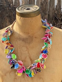 a necklace made out of colorful beads on a mannequin