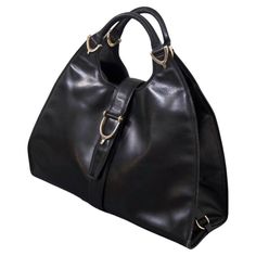 Gucci Vintage Black Leather Stirrup Hobo Handbag | From a unique collection of rare vintage Hobo Bags at https://www.1stdibs.com/fashion/handbags-purses-bags/shoulder-bags/hobo-bags/. Dome Bag, Trapezoid Shape, Leather Bag Design, Gucci Vintage, Black Leather Bag, Hobo Handbag, Italian Craftsmanship, Handbags And Purses, Stirrups