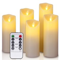 five lit candles with remote control on white background