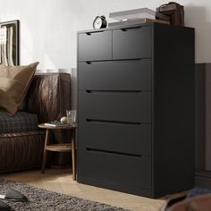 a black chest of drawers in a living room