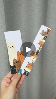 someone holding up an animal card with the letter v in it's middle hand