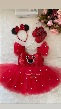 a red minnie mouse dress and matching headbands