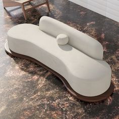 a white couch sitting on top of a marble floor