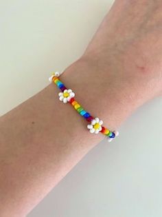 a woman's arm with a colorful bracelet on it