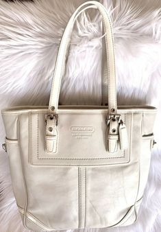 Coach F10412 White Leather Legacy Hampton Gallery Tote Bag - MSRP $398. Condition is "Pre-owned". Shipped with USPS Priority Mail. Good Used condition.  Some wear on corners, minor wear on handles (see pictures). Interior shows some minor yellowing. Coach Swagger Bag, Michael Kors Hamilton, See Pictures, Priority Mail, White Leather, The Hamptons, Bags Handbags, Top Handle Bag, Shoe Accessories