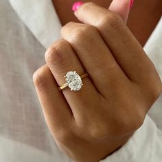 a woman's hand with a diamond ring on it