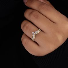 a woman's hand with a diamond ring on it