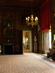 an ornately decorated room with chandeliers and paintings