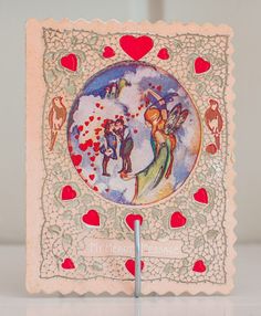 a card with an angel and hearts on it