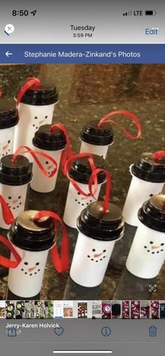 a group of coffee cups with red ribbons tied around them on top of a table