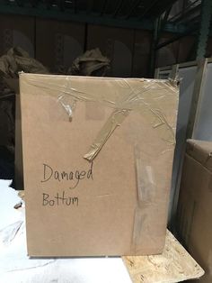 a cardboard box with the words damaged bottom