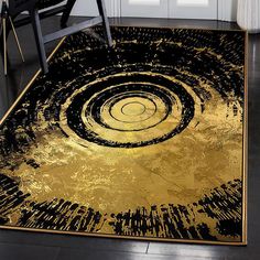 a black and gold area rug with an abstract design on the floor in front of a white door