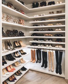 a walk in closet filled with lots of shoes and high heeled boots on shelves