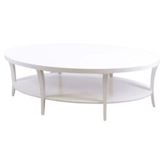 a white coffee table with two shelves on each side and an oval shaped shelf at the bottom