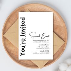 a white business card sitting on top of a wooden plate