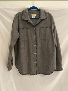 "Gorgeous vintage wool Buttondown coat with silver buttons  Size: Large Measurements: Bust: 44\" Length: 31\" Sleeve: 20\" Material: 80% Wool  Brand: St. John's Bay Condition: like new This is a vintage or upcycled item that has been purchased from a local thrift store and has been pre-loved. Any major flaws or damage will be disclosed in the item description and pictures will be provided of flaws/damage. All vintage/thrifted items have been sanitized before sending out to my lovely customers. If you have any questions please feel free to message me here on Etsy or on my instagram page @lani.vintage" Wool Coat With Buttons And Long Sleeves, Wool Coat With Buttons, Long Wool Coat With Buttons, Button-up Wool Coat For Winter, Winter Wool Button-up Coat With Buttons, Fall Button-up Wool Coat, Vintage Gray Outerwear With Buttons, Wool Coat With Button Closure, Vintage Wool Coat With Button Closure