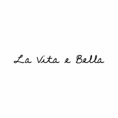 the words la vita a bella written in black ink