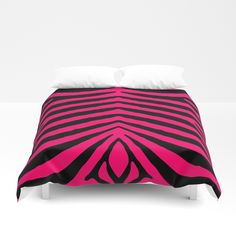 a bed with pink and black designs on it