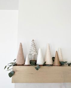 a group of small trees sitting on top of a mantle