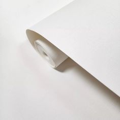 an image of a white wallpaper with a roll of tape sticking out of it