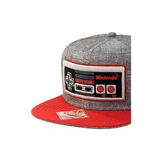 This Nintendo Hat features a large, high quality embroidered Classic NES Nintendo controller on front of a grey/red hat cap. The embroidery is raised and all this is on an Original Snapback brand hat. Great for Men, Women or Teens this one size fits most adjustable cap has a snapback with multiple sizing options that truly makes it One Size FIts Most OSFM. It is the great gift for any Nintendo fan. Gray Trucker Hat With Embroidered Logo, Gray Baseball Cap With Logo Patch, Gray Hat With Embroidered Logo For Streetwear, Gray Snapback Hat With Logo Patch And Curved Brim, Gray Trucker Hat With Embroidered Logo And Flat Bill, Gray Cap With Embroidered Logo, Gray Snapback Baseball Cap With Embroidered Logo, Red Snapback Hat With Logo Patch, Gray Snapback Hat With Embroidered Logo