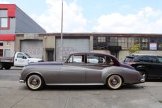 an old car parked in front of a building