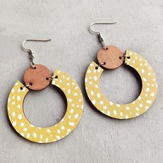 Add a touch of elegance to your outfit with our Beautiful Yellow Wood Circle Earrings. Crafted with care, these unique earrings are perfect for any occasion, featuring a soft and delicate yellow hue that adds a touch of femininity and sophistication to your look. 2 inches Handmade Yellow Circle Earrings, Yellow Single Dangle Earring, Single Yellow Dangle Earring, Trendy Yellow Earrings With Ear Wire, Yellow Dangle Hoop Earrings With Ear Wire, Trendy Yellow Hoop Earrings As Gift, Trendy Yellow Hoop Earrings For Gift, Trendy Yellow Drop Earrings, Handmade Yellow Drop Hoop Earrings