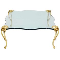 a glass and gold coffee table